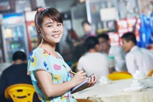 Chinese Waitress Of Restaurant With Menu